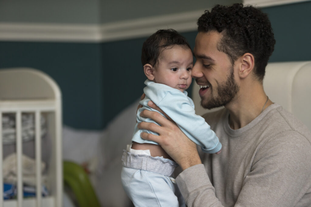 Child Support Lawyer Brandon, FL with a young father holding a baby