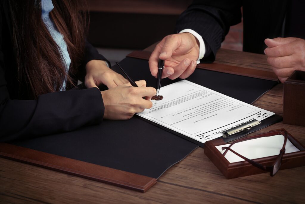 Murder Defense Lawyer Brandon, FL with two people in suits reviewing paperwork